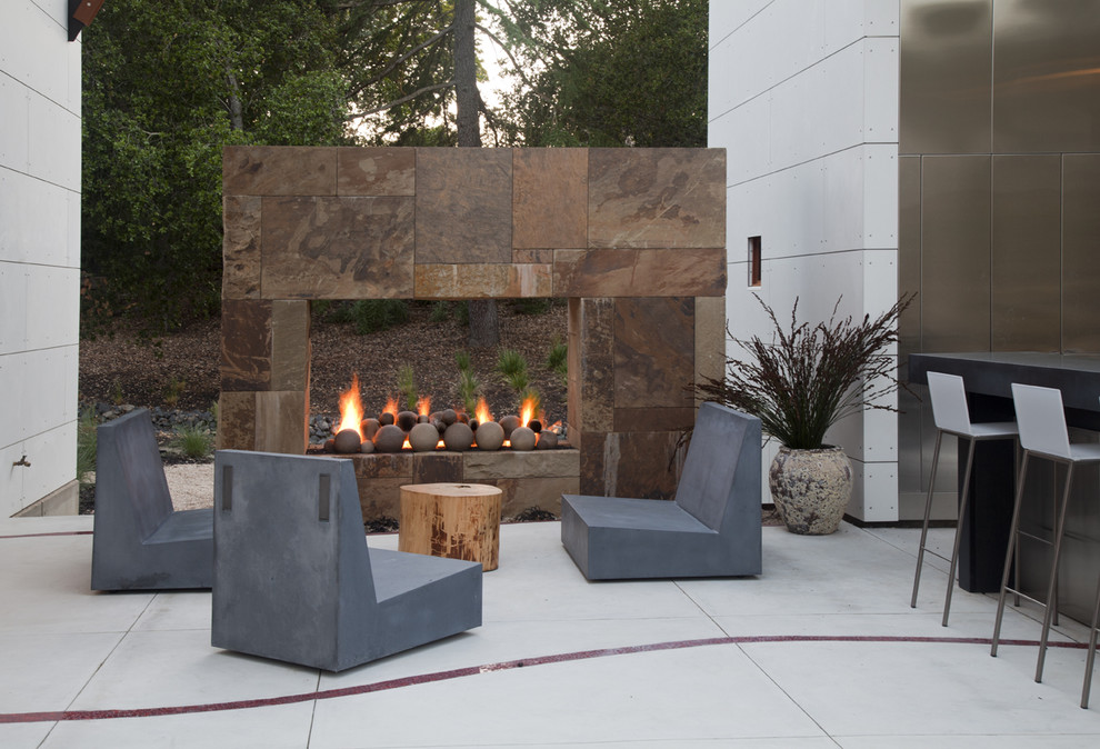 Inspiration for a large contemporary backyard concrete patio remodel in San Francisco with no cover and a fireplace