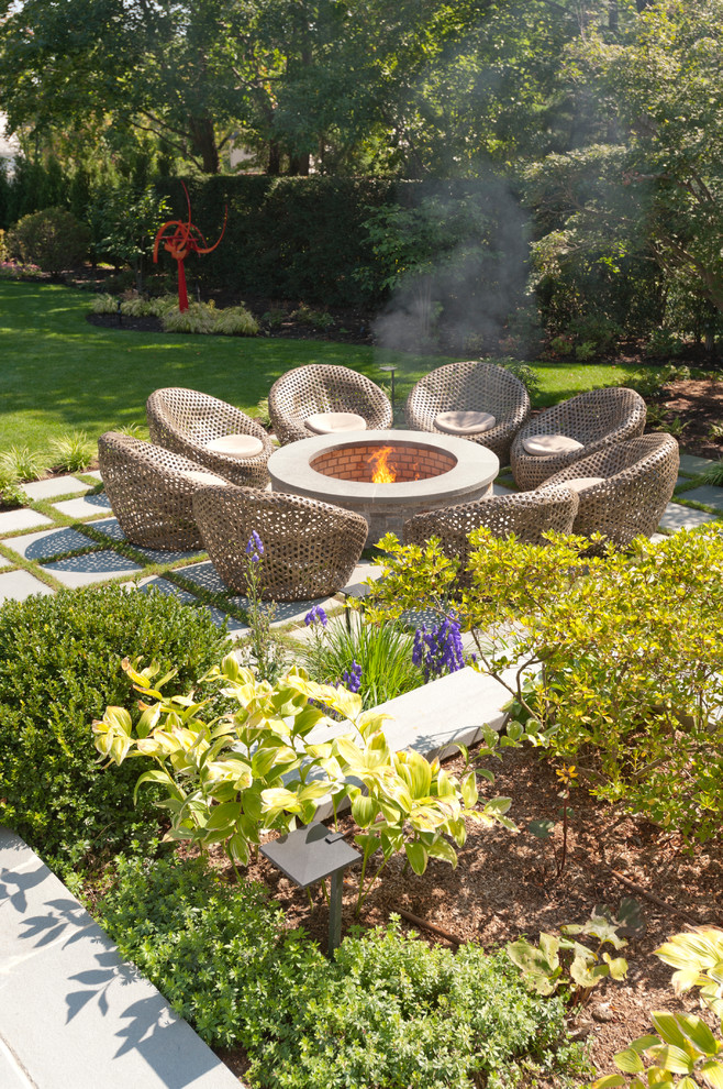 Example of a beach style patio design in New York with a fire pit and no cover