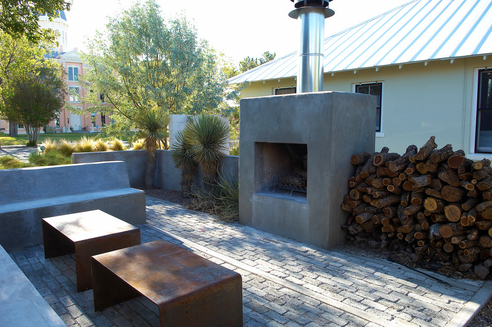 Trendy courtyard patio photo in Austin with a fire pit