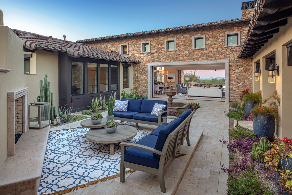 Inspiration for a southwestern courtyard patio remodel in Orange County with a fireplace and no cover