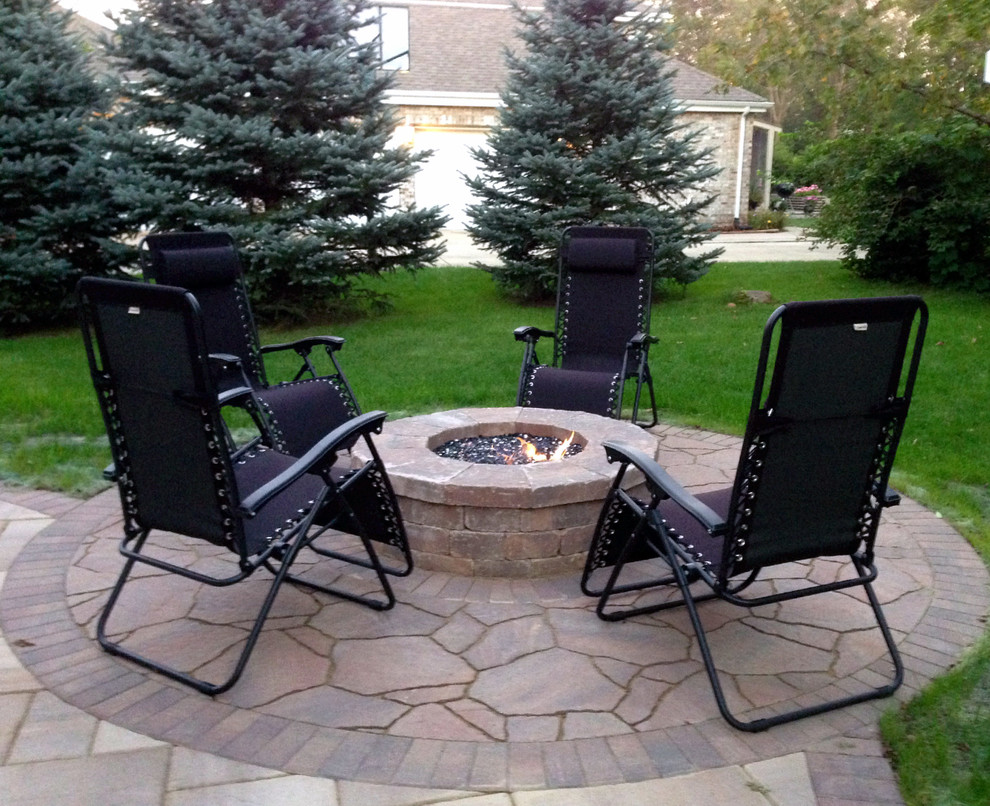 Design ideas for a medium sized classic back patio in Chicago with a fire feature, brick paving and no cover.