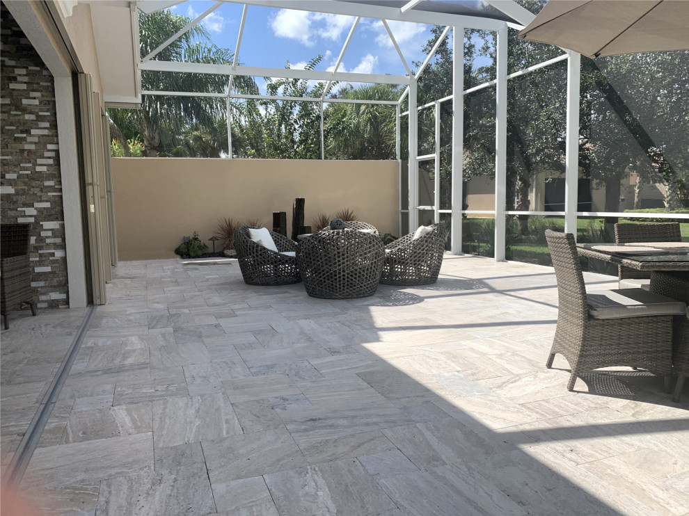 Design ideas for a medium sized traditional back patio in Miami with a water feature and natural stone paving.