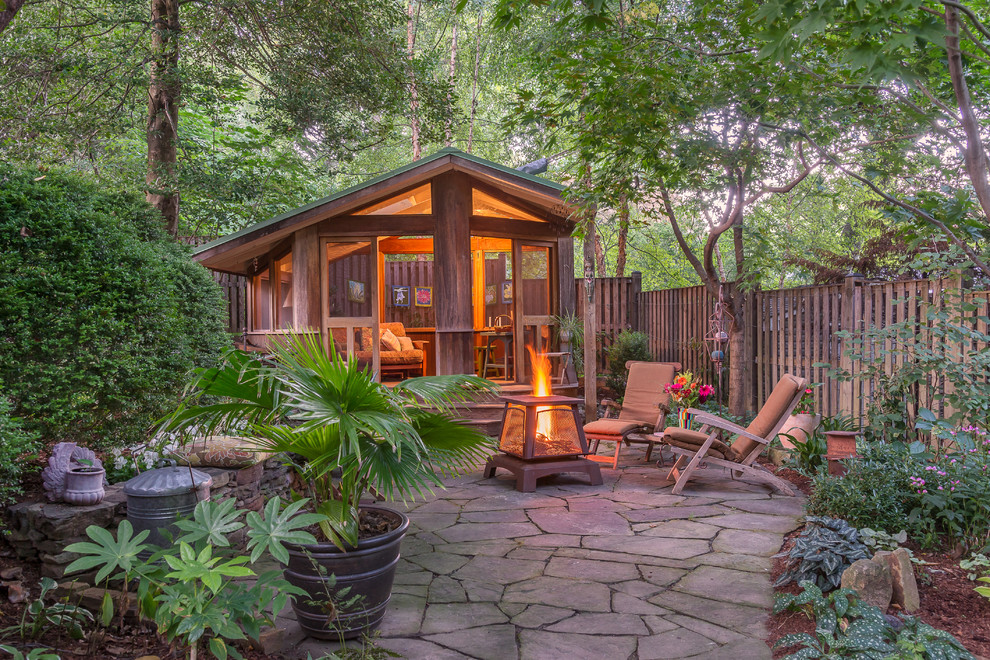 Mid-sized mountain style backyard stone patio photo in DC Metro with a fire pit and no cover