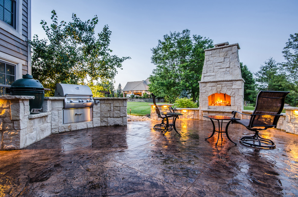 Inspiration for a medium sized traditional back patio in Kansas City with an outdoor kitchen, stamped concrete and no cover.