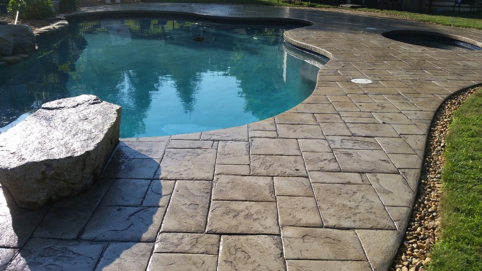 Inspiration for a timeless stamped concrete pool remodel in Boston
