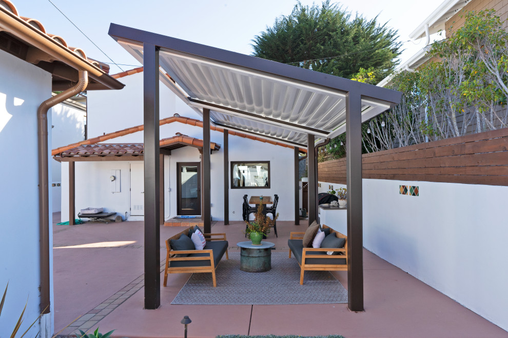 Photo of a medium sized mediterranean back patio in San Luis Obispo with an outdoor kitchen, concrete slabs and a pergola.