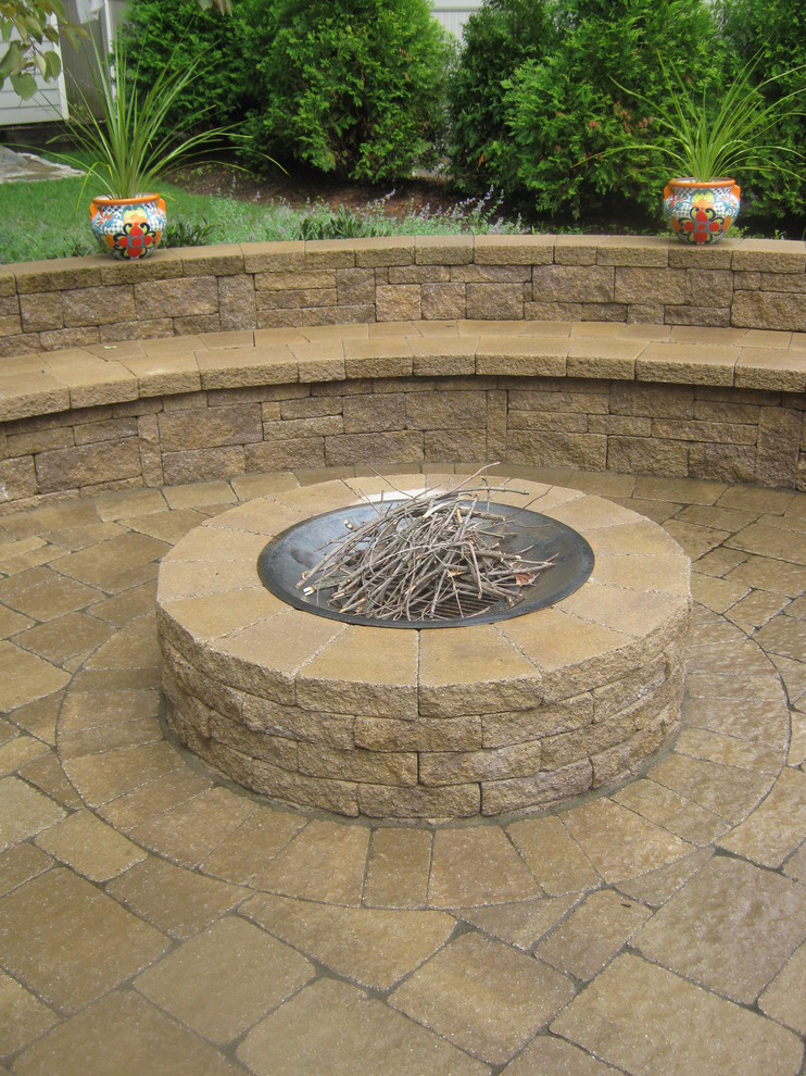 Patio - mid-sized traditional backyard brick patio idea in New York with a fire pit and no cover