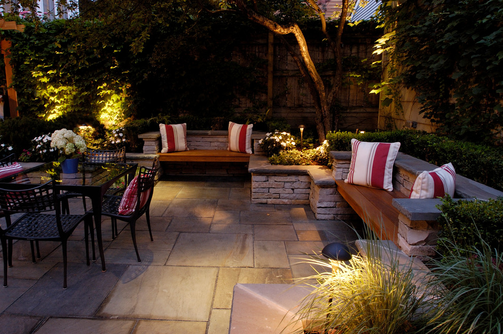 Patio - mid-sized traditional backyard stone patio idea in Chicago with no cover