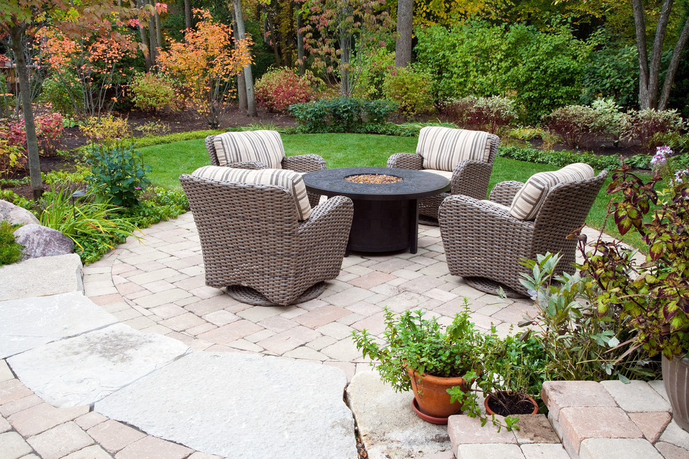 Large elegant backyard concrete paver patio photo in Chicago with a fire pit and no cover