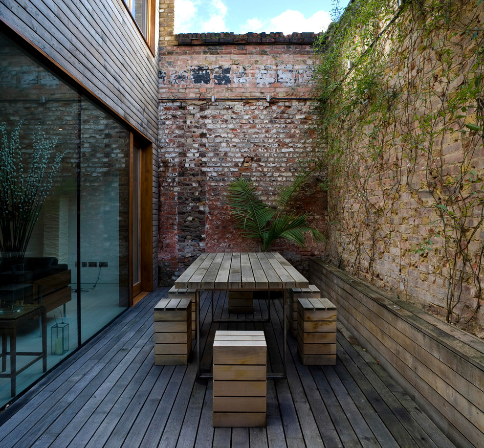 Contemporary courtyard patio in London with decking and no cover.