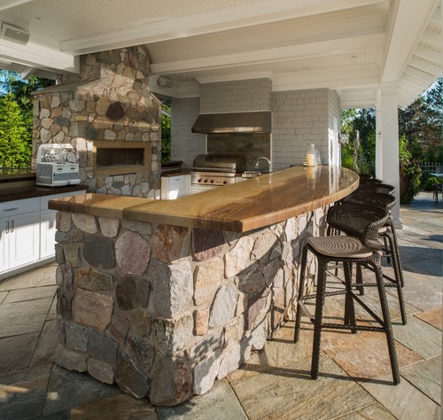 Rustic Charm: Natural Wood Countertop Kitchen Bar with a Huge Stone Fireplace