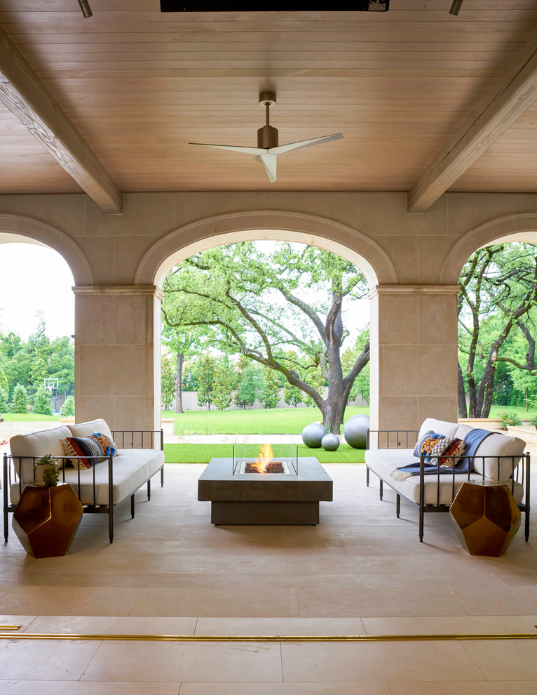 Photo of a mediterranean patio in Dallas with a roof extension.