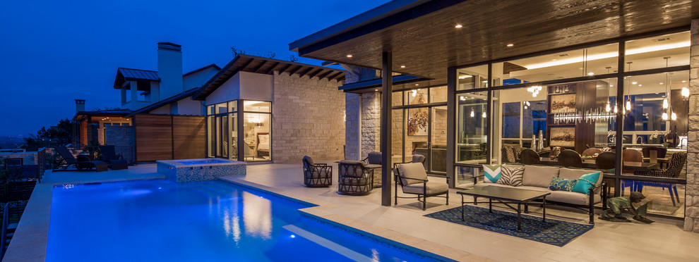 Inspiration for a contemporary backyard patio remodel in Austin with a roof extension