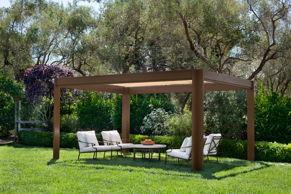 Example of a trendy backyard patio design in Los Angeles with a pergola