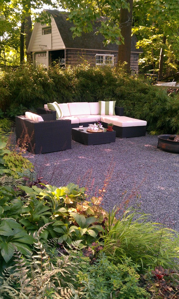 Photo of a small modern back patio in New York with a fire feature, gravel and no cover.