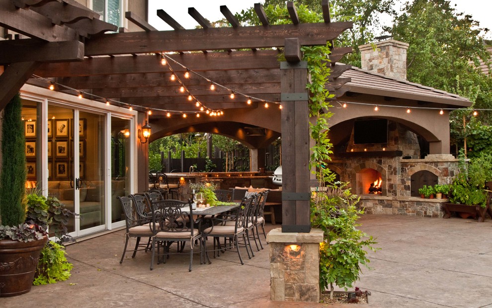 Example of a tuscan backyard concrete patio design in San Francisco with a fire pit and a pergola