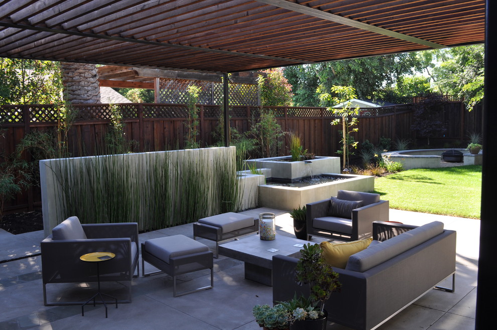 Inspiration for a contemporary patio in San Francisco with a pergola and a water feature.