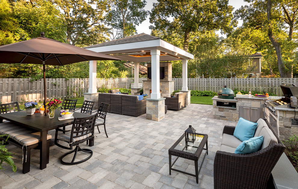 Inspiration for a transitional backyard concrete paver patio kitchen remodel in Chicago with a gazebo