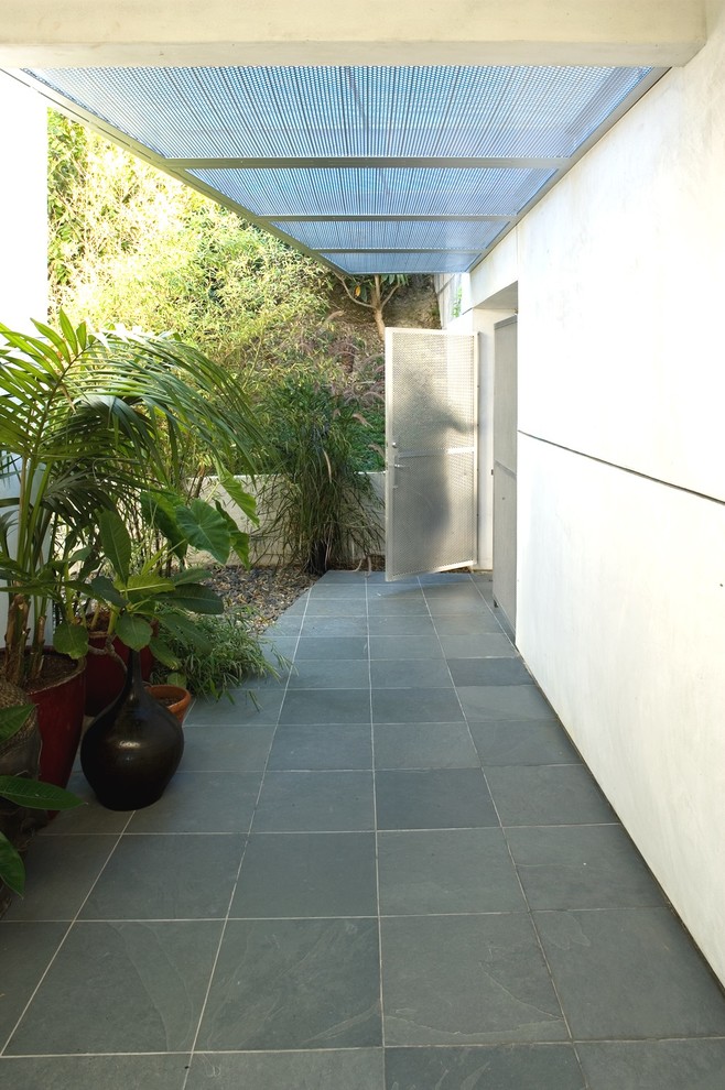 Patio - tropical patio idea in Los Angeles