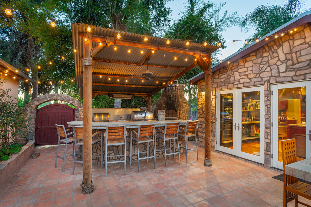 Mid-sized island style backyard tile patio kitchen photo in San Diego with a gazebo