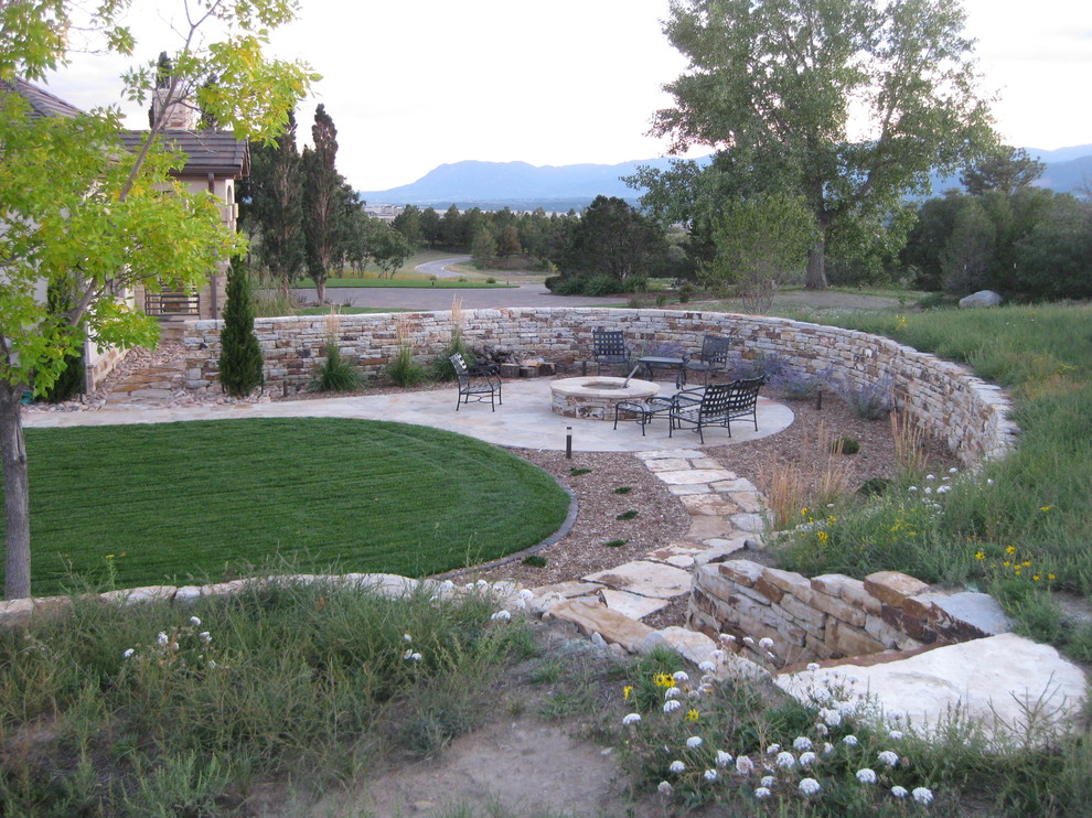 Large elegant backyard patio photo in Denver with a fire pit and no cover
