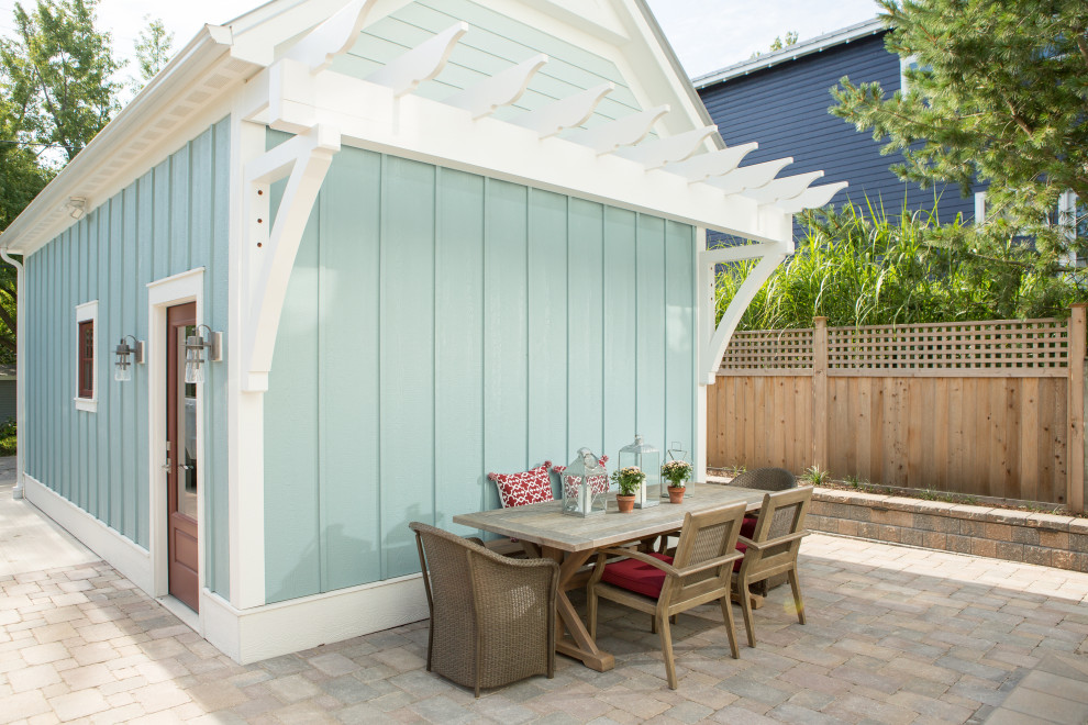 Idee per un piccolo patio o portico stile marino dietro casa con pavimentazioni in pietra naturale e una pergola