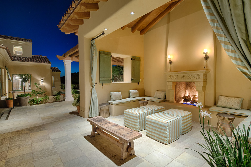 Inspiration for a mediterranean patio remodel in Phoenix with a gazebo and a fireplace