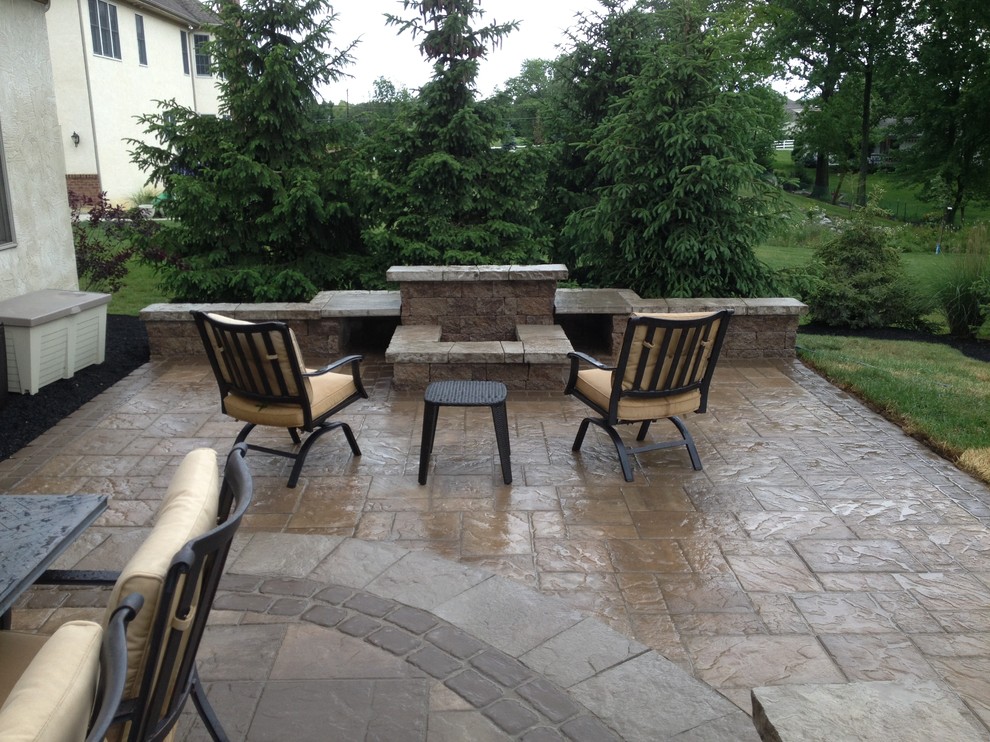 Inspiration for a medium sized classic back patio in Columbus with a fire feature and concrete paving.