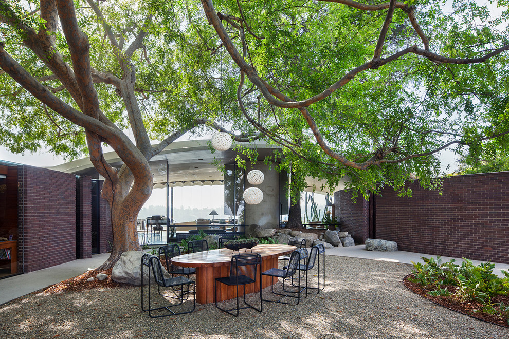 1960s courtyard gravel patio photo in Los Angeles with no cover