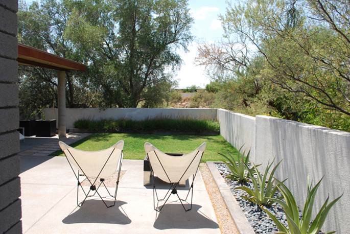 Inspiration for a small contemporary backyard concrete patio remodel in Phoenix with a roof extension
