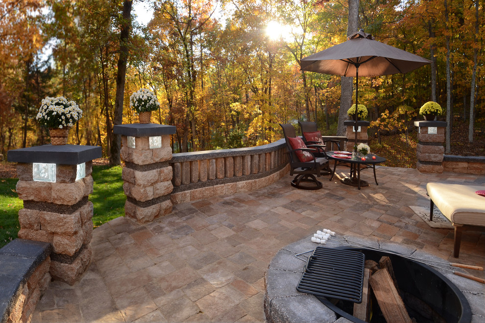 This is an example of a rustic back patio in Other with concrete paving.