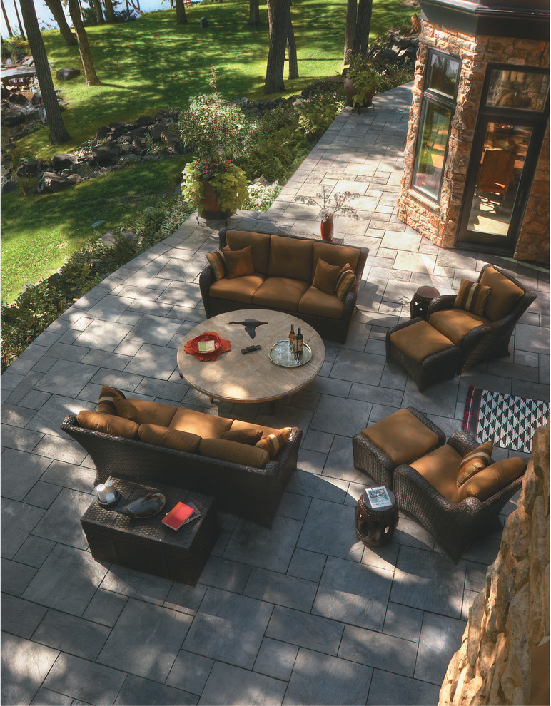 Classic back patio in Other with concrete paving.