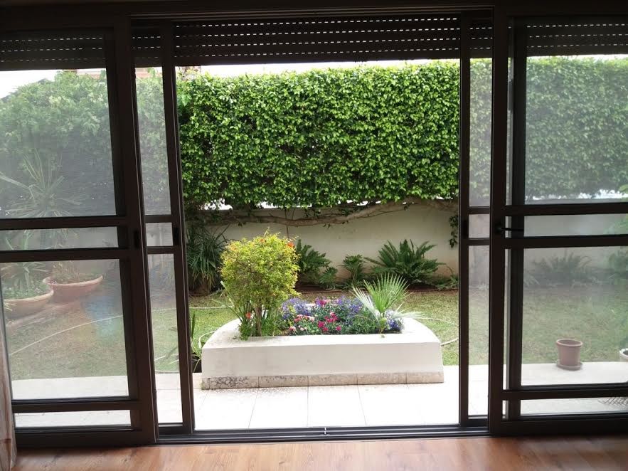 Medium sized traditional back patio in Miami with a potted garden, decomposed granite and no cover.