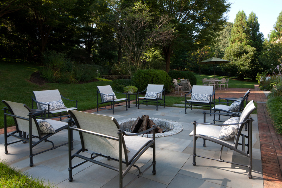 Example of a classic patio design in Baltimore with a fire pit and no cover