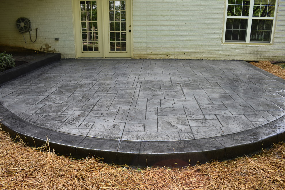 Example of a mid-sized backyard stamped concrete patio design in DC Metro