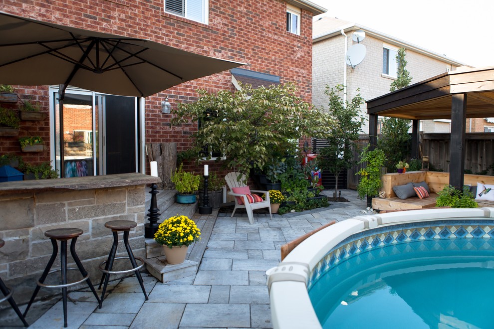Photo of a medium sized traditional back patio in Toronto with a water feature, concrete paving and a gazebo.