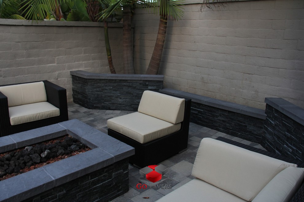 Inspiration for a small contemporary back patio in Los Angeles with a fire feature and concrete paving.