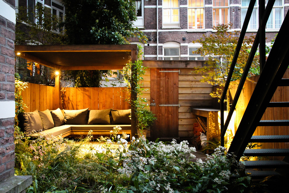 Inspiration for a contemporary patio remodel in Amsterdam with a pergola