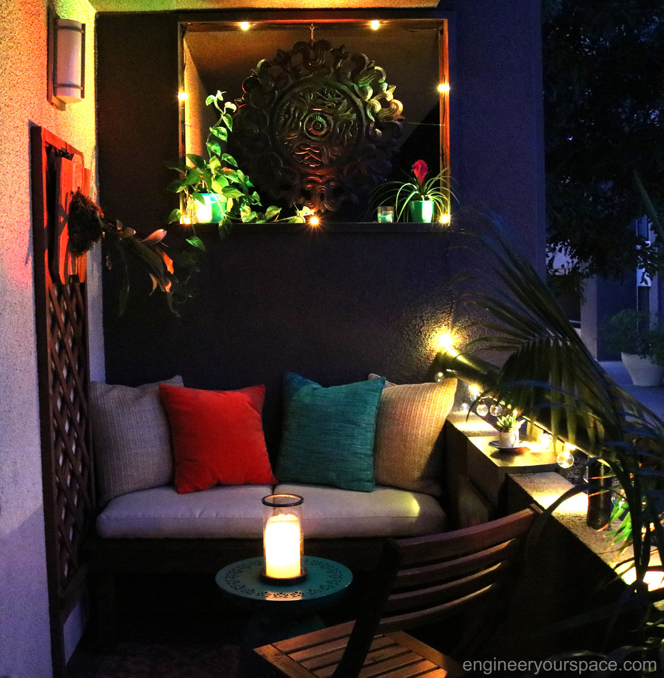 Patio - small tropical patio idea in Los Angeles with a roof extension