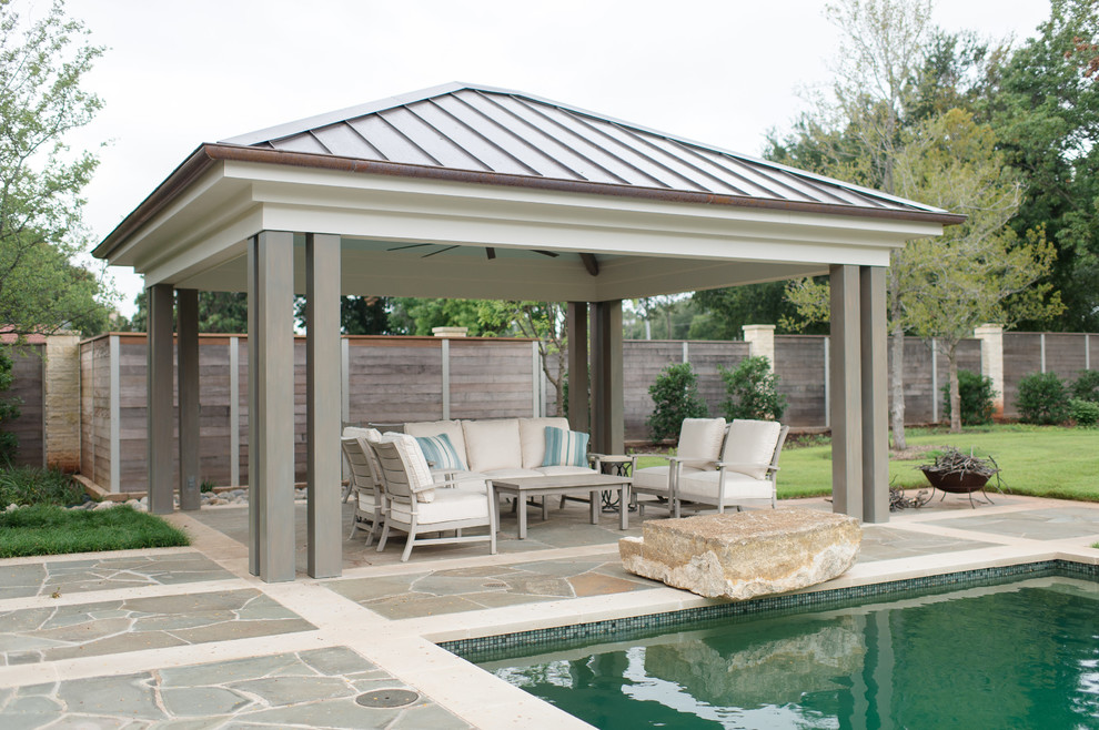 Inspiration for a mid-sized transitional backyard stone patio remodel in Austin with a gazebo