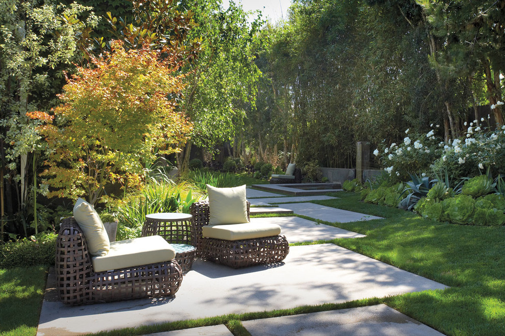 This is an example of a contemporary patio in Orange County with a water feature.