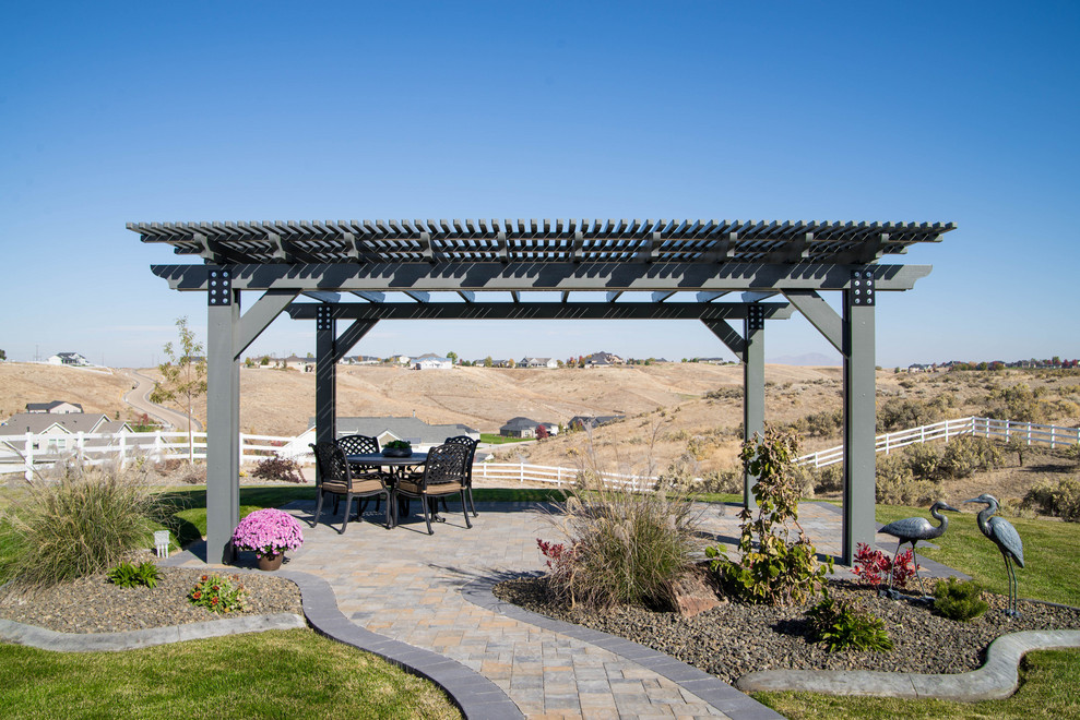 Example of a large arts and crafts backyard patio design in Boise with a pergola