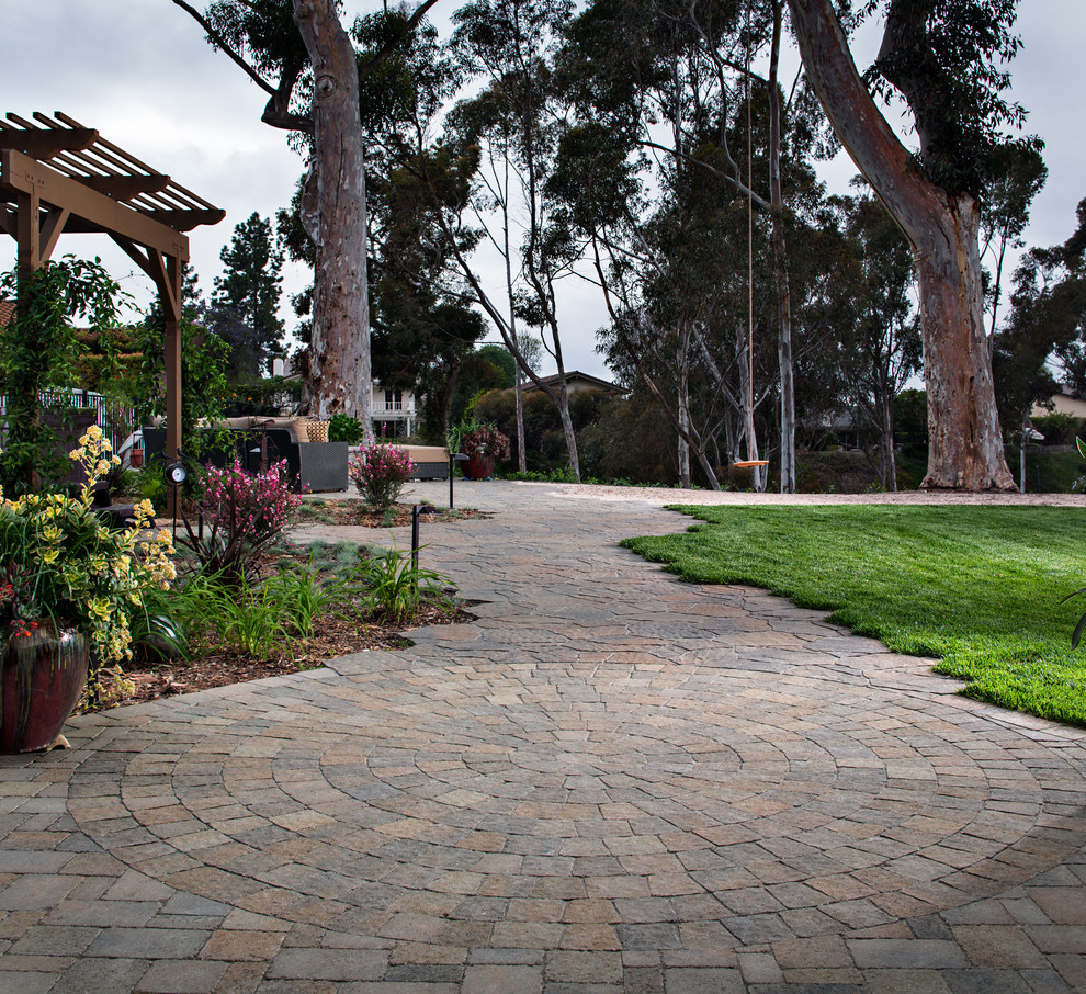 Patio - large transitional backyard concrete paver patio idea in San Diego with no cover
