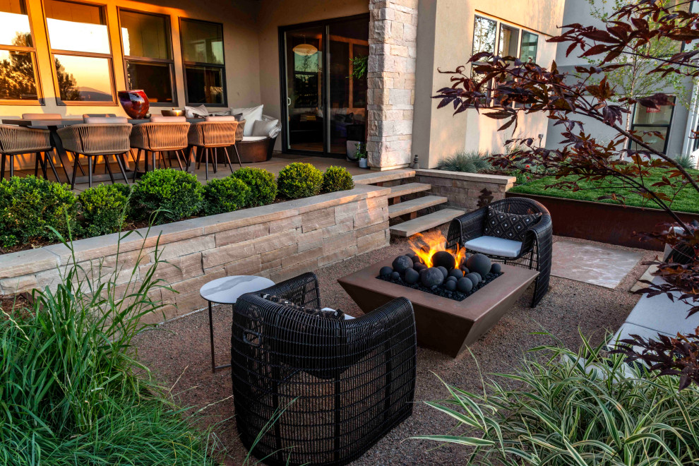 Design ideas for a small contemporary back patio in Denver with natural stone paving.