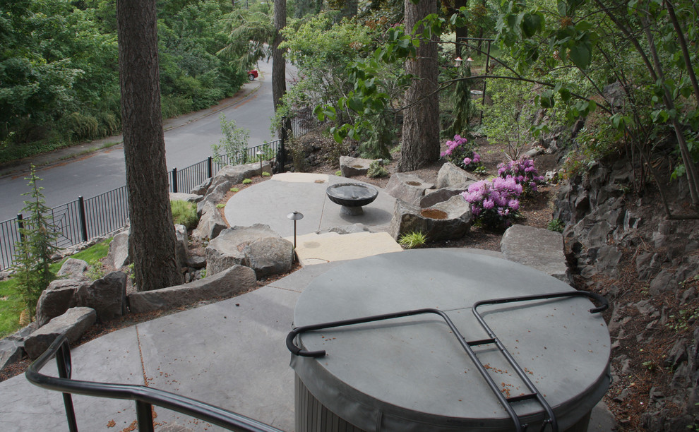 Example of a small arts and crafts backyard stamped concrete patio design in Seattle with a fire pit and no cover