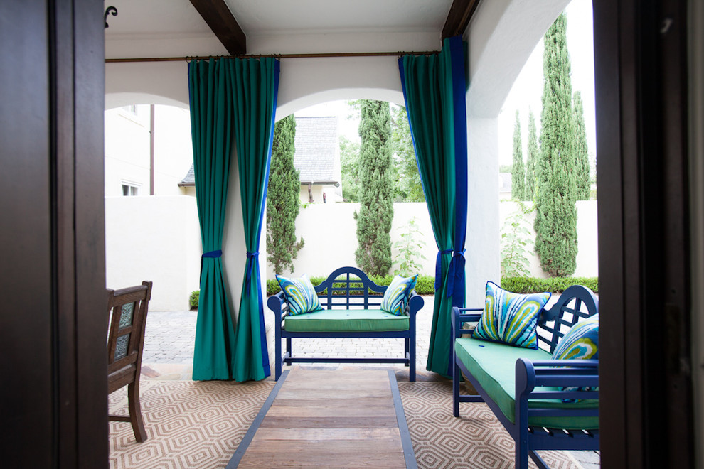 Patio - mediterranean patio idea in Houston with a roof extension
