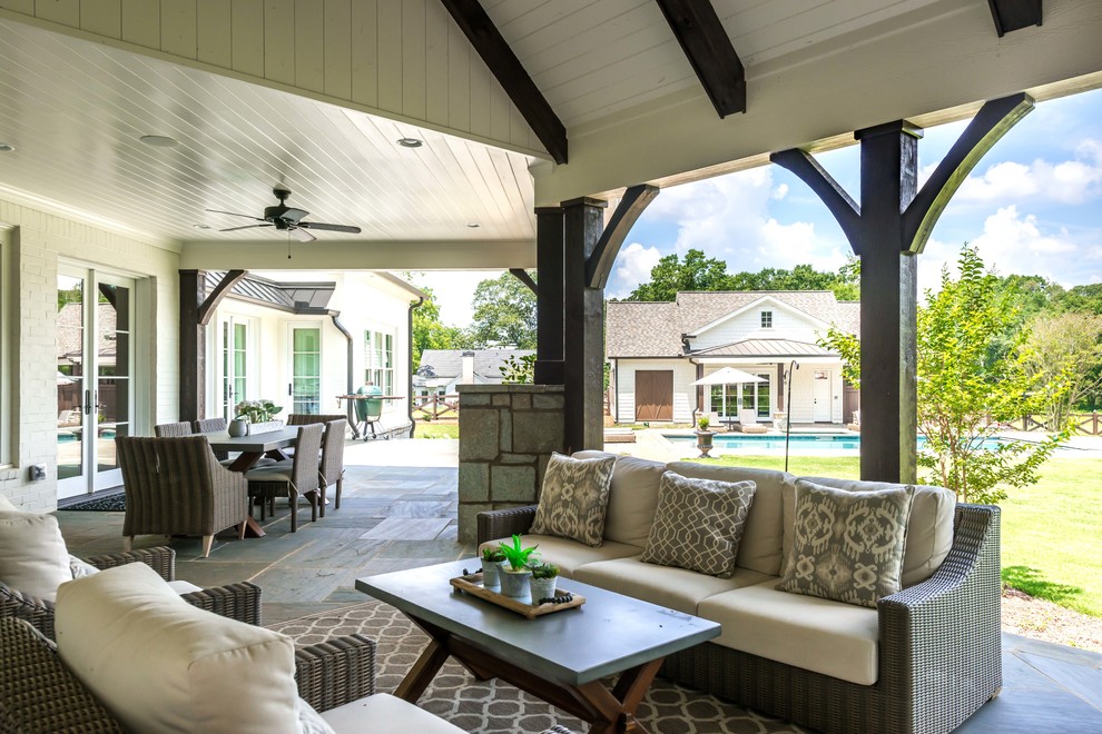 Photo of a coastal back patio in Atlanta with an outdoor kitchen and a roof extension.