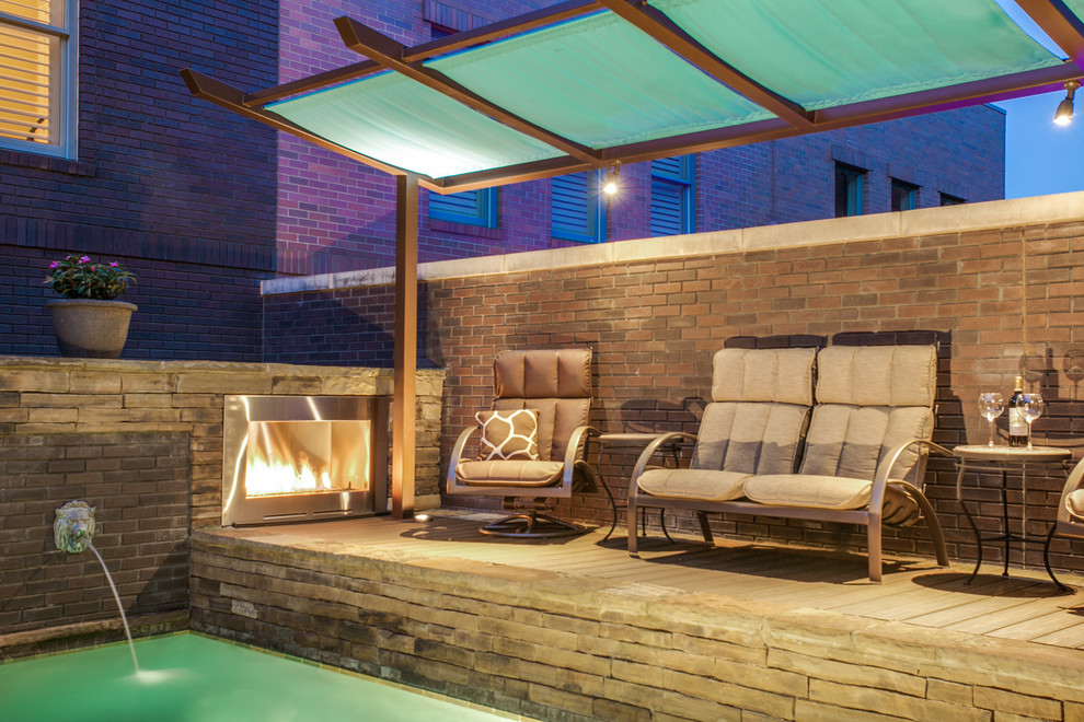 Small minimalist backyard patio photo in Dallas with a fire pit, decking and a pergola