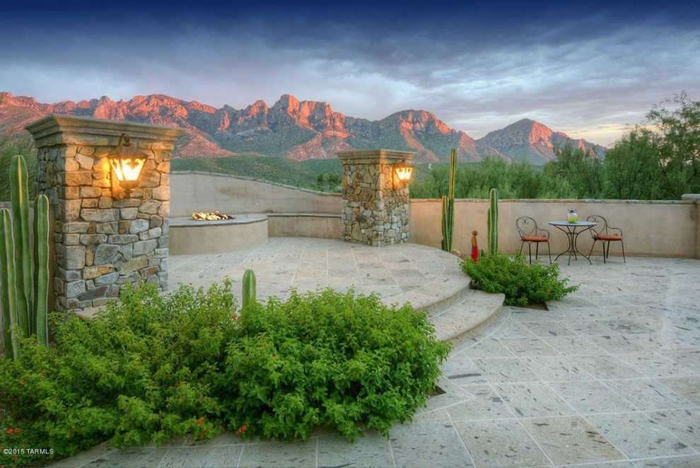 Inspiration for a large back patio in Phoenix with a fire feature, no cover and natural stone paving.