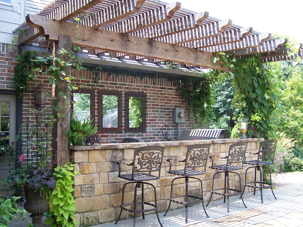 Large elegant backyard tile patio kitchen photo in Dallas with a pergola